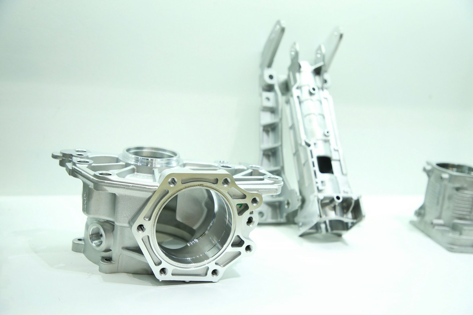 A couple of metal aluminium parts sitting on a table, ready for finishing